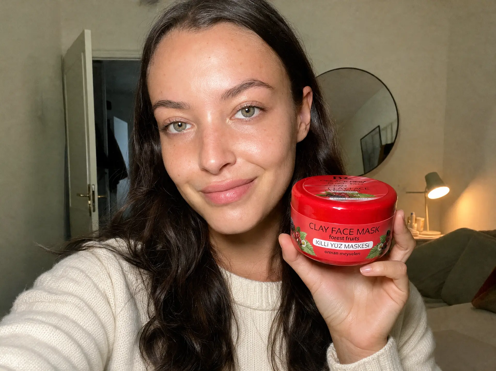 Customer holding the Forest Fruits Clay Face Mask at home